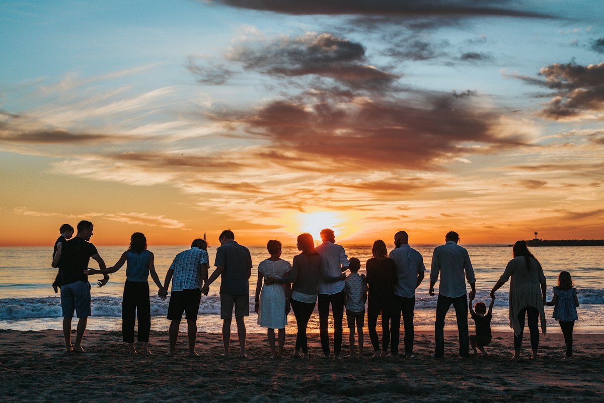 Family looking at the sea at sunset
